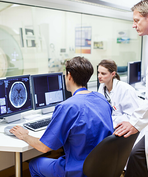 Doctors at a computer tomography exam Doctors at a computer tomography exam